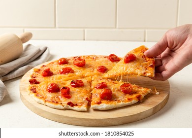 Hand Picking Up A Cheese Pizza Slice