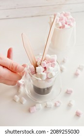 Hand Picking Up Cup Of Coffee With Sugar And Marshmallows.