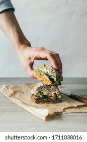 
Hand Picking Up A Healthy And Delicious Sandwich With Vegetables