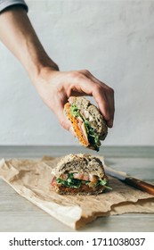 
Hand Picking Up A Healthy And Delicious Sandwich With Vegetables