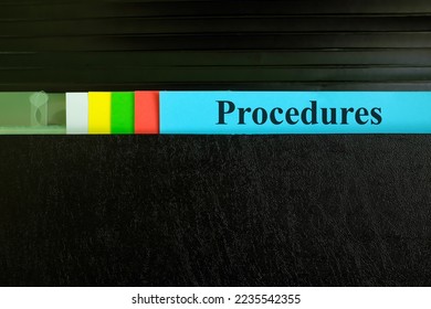Hand picking procedures file record in black binder folder. Work procedure concept.