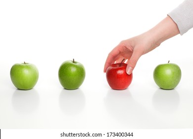 Hand Picking Red Apple Among Green Apples