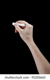 Hand With Piece Of Chalk Isolated On Black