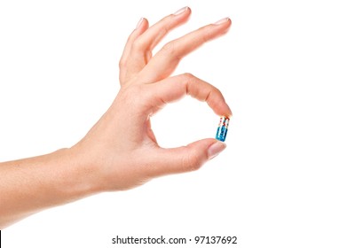 Hand and pill isolated on white background