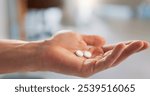 Hand, pills and person with medicine, healthcare and wellness with prescription, capsules and pharmacy. Clinic, medical professional and palm with antibiotics for recovery, treatment and supplements