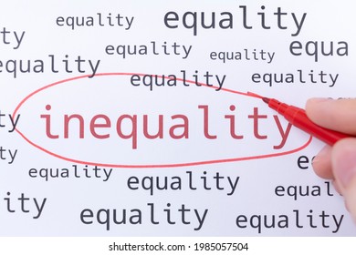 A hand with a pink marker is circling the word INEQUALITY.