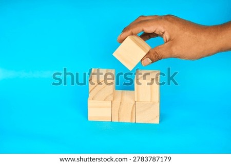 Hand placing a block with customizable space for text or ideas, representing copy space, planning, creativity, and visual communication.
