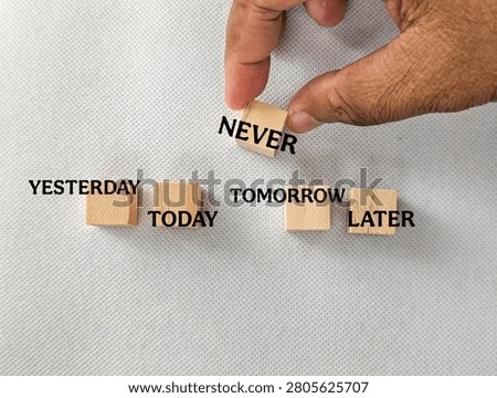 Hand placing never block between yesterday, today, tomorrow, and later, symbolizing procrastination, missed opportunities, decision making, and time management.