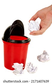 Hand Placing Paper In Trash And Some Other Crumpled Paper Balls