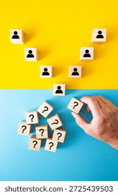Hand placing a question mark block into a funnel of user icons, representing customer acquisition