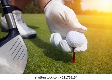 Hand Placing A Tee With Golf Ball