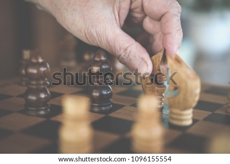 hand playing chess game. plan & analysis. risk and strategy concept