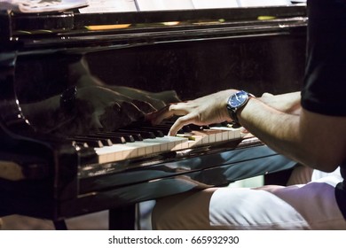 Hand playing on piano keyboard - Shutterstock ID 665932930