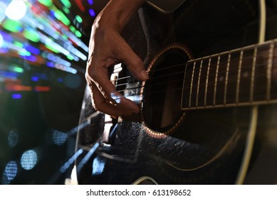 hand plucking guitar string