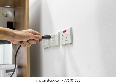 Hand are plugged in or unplugged electricity. Separated from a white background. - Shutterstock ID 776704231