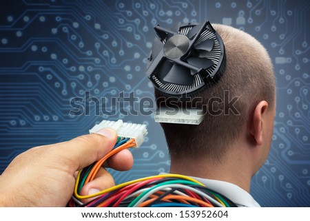 Hand plugging power cables into the head of cyborg