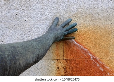 Hand Plugging A Water Leak