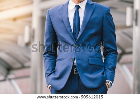 Hand in pocket with wrist watch in a business suit close up. soft focus
