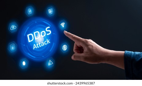 A hand pointing to a blue circle with the word ddos attack in white. The circle is surrounded by various icons, including a light, a cloud, and a globe. Concept of a cyber attack