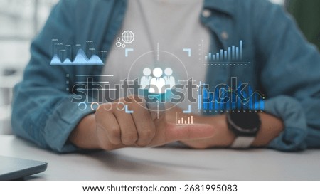 Hand pointing at digital interface with target icon and data analytics graphs, representing customer targeting, data-driven strategy, and business intelligence technology.