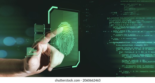 Hand pointing at glowing finger print interface on dark background with coding language. Security and biometrics concept
