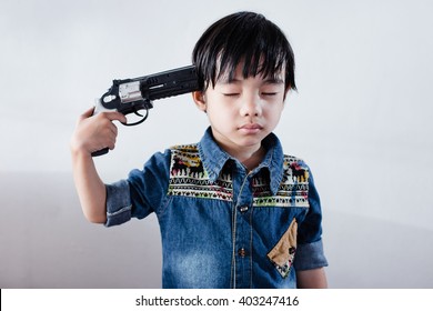 Hand Pointing Gun At The Head Boy