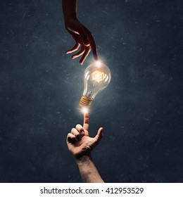 Hand pointing light bulb