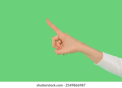 Hand pointing upwards against a vibrant green background in a clear gesture signaling attention or direction - Powered by Shutterstock