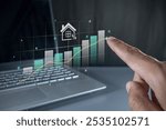 Hand pointing to a virtual graph. House price rising up or real estate property growth concept.