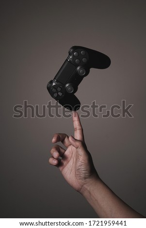 Man’s hand points up to black joystick