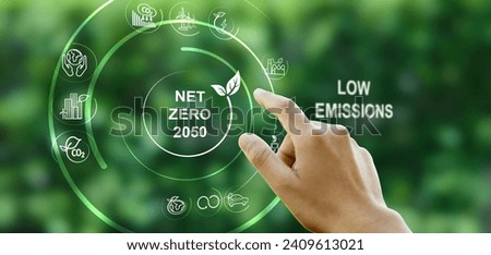 Hand points to a touchscreen with the word Net Zero and an icon against a green background. Concept, goal, zero greenhouse gas emissions. and a long-term climate-neutral strategy.
