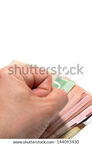 Hand pounding on a stack of bank notes