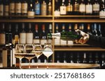 Hand Pouring Champagne Into Glasses in Wooden Cellar, Close up