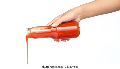 Hand Pouring Chili Sauce From Bottle Isolated On White Background