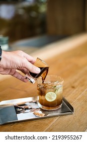 Someone’s Hand Pouring Coffee Into  Soda Glass