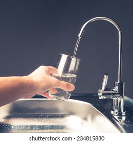 Hand Pouring A Glass Of Water From Filter Tap