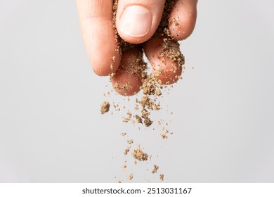 Hand pouring ground peppercorn mixture, black, white, red and green pepper. - Powered by Shutterstock