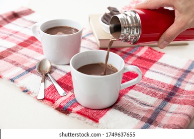 Hand Pouring Hot Chocolat In A Cup