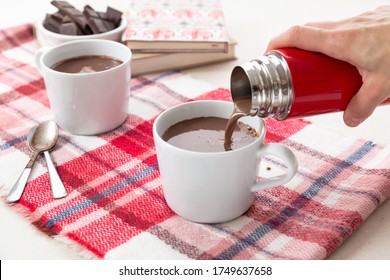 Hand Pouring Hot Chocolat In A Cup