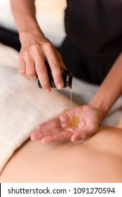 Hand Pouring Oil For Massage In Spa