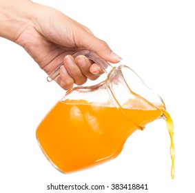 Hand Pouring Orange Juice From Jug Isolated On White Background