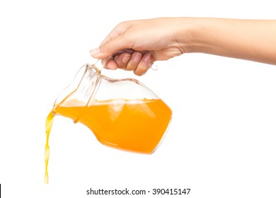 Hand Pouring Orange Juice From Jug Isolated On White Background