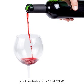 Hand Pouring Red Wine Into A Wineglass From An Unlabelled Wine Bottle Isolated On White