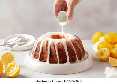 Hand Pouring Sugar Drizzle In A Lemon Cake