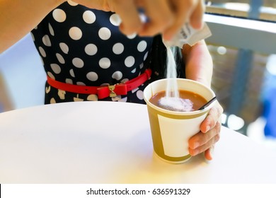 Hand Pouring Unhealthy Non Dairy Creamer From Sachet Into Hot Coffee