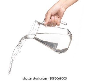 Hand Pouring Water From Glass Jug To Glass Isolated On A White Background