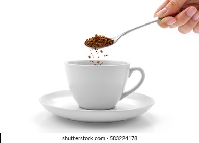 Hand Pours Instant Coffee From A Spoon In A Coffee Cup