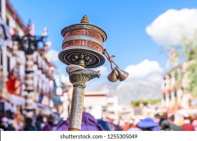 hand prayer wheel in Jokhang temple. The characters written (in Newari language) on the wheels are the mantras "Om Mani Padme Hum", each word means "sacred, bead, lotus flower, spirit of enlightenment