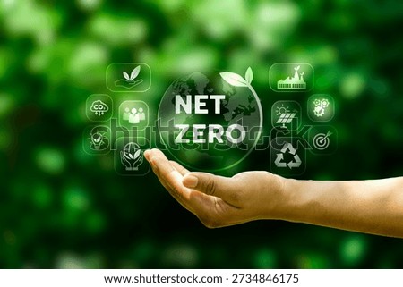 Hand presenting net zero globe with sustainability icons on green background, illustrating carbon reduction strategy, climate responsibility, renewable energy transition, and environmental governance
