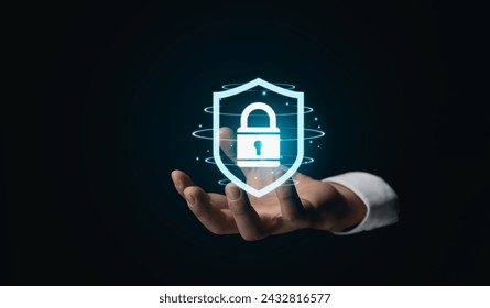 Hand Presenting Virtual Security Shield Symbol. An outstretched hand holding displays a glowing virtual security shield, symbolizing advanced protection in the digital age. Cyber Security concept. - Powered by Shutterstock